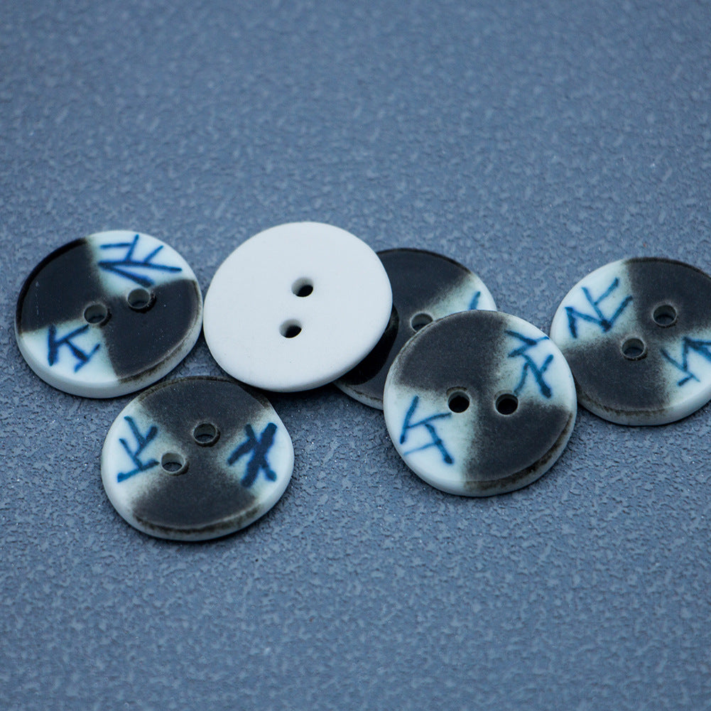 Ceramic button set with blue lattice motifs on dark and light bases, two-hole each