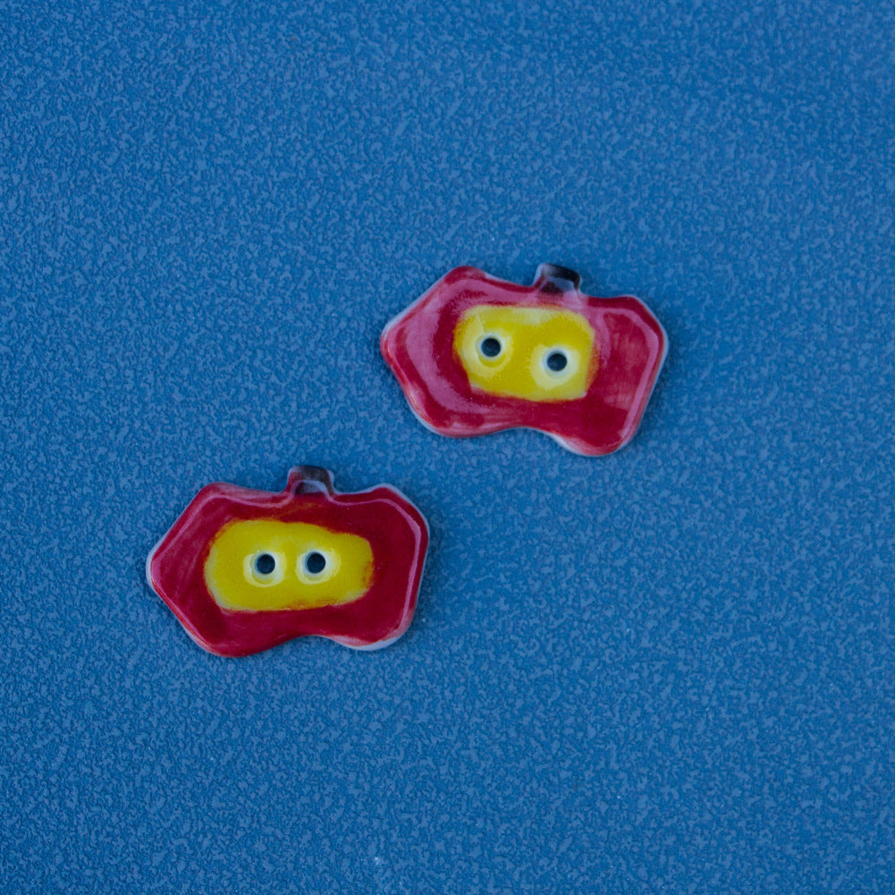 Ceramic apple buttons with red rim and yellow face, blue eyes and two holes (Style A)