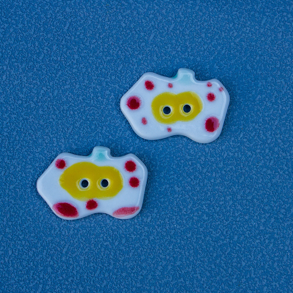 Ceramic apple button with white face and red dot accents, two holes (Style C)