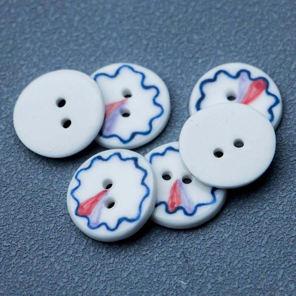 Set of 4 blue-and-white ceramic 2-hole buttons with red center accents