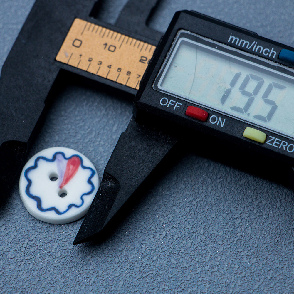 19.5mm blue-and-white ceramic 2-hole button with red center, shown with caliper