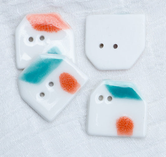Ceramic house DIY buttons, white with two holes; blue window and orange roof highlights