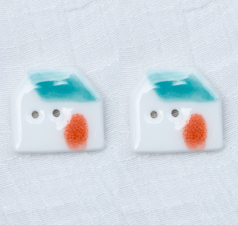 Ceramic house buttons, white with blue roof, orange round door, two-hole face