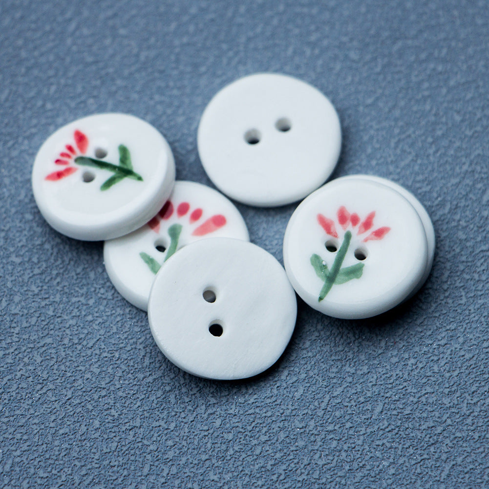 White round ceramic buttons, two holes each, red flower motif with green stems