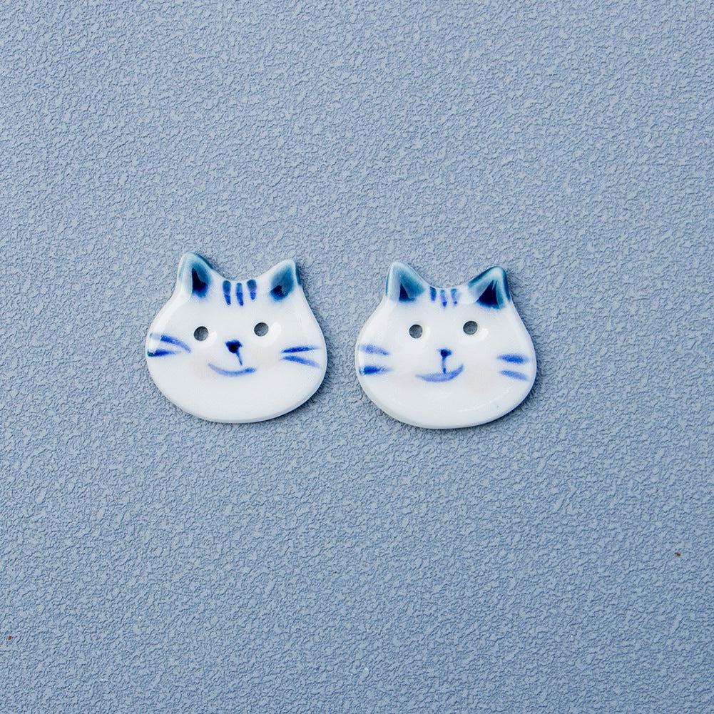 Cat ceramic buttons with blue ears, white faces, blue whiskers and nose dots