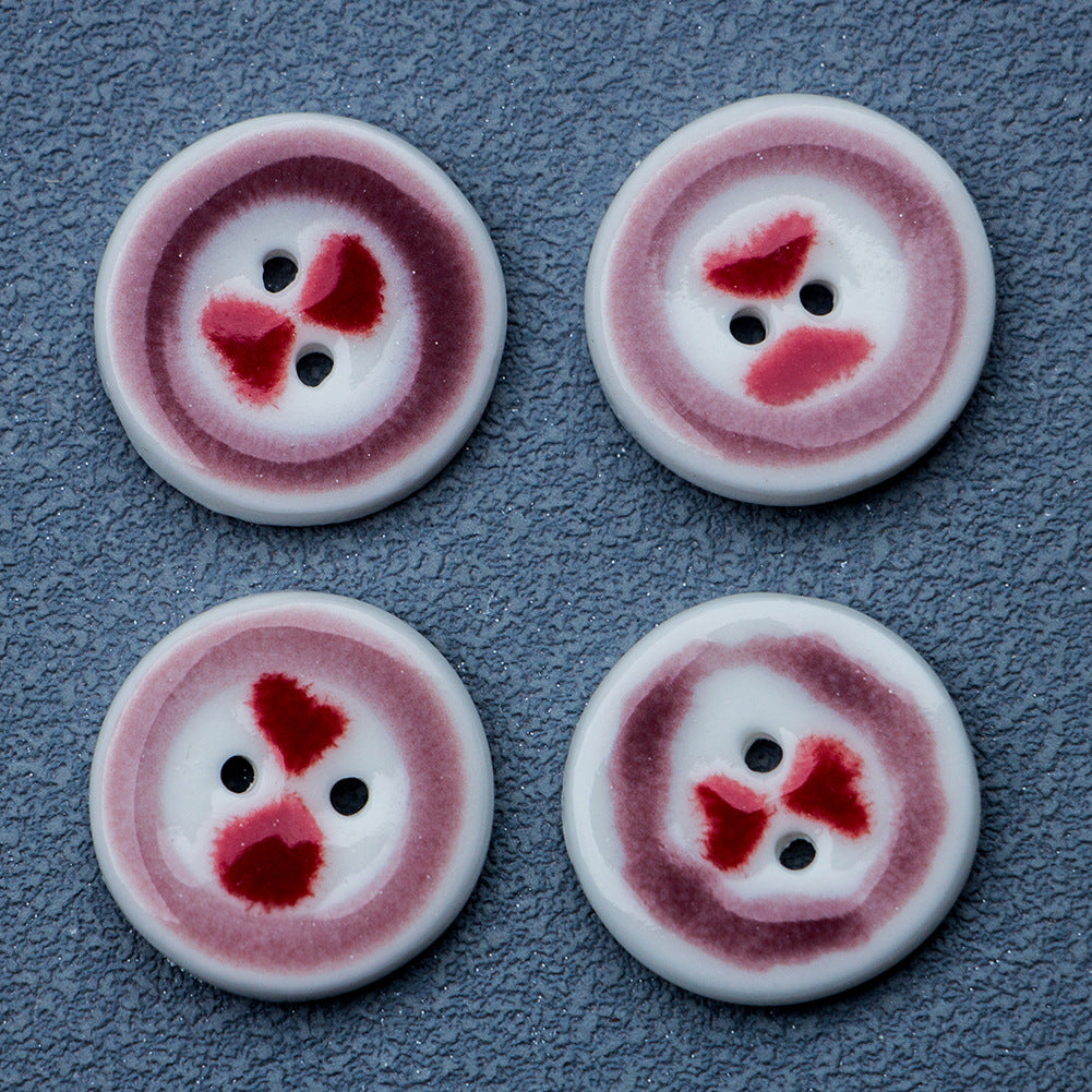 Red heart patterned round buttons with two holes and pale pink rim
