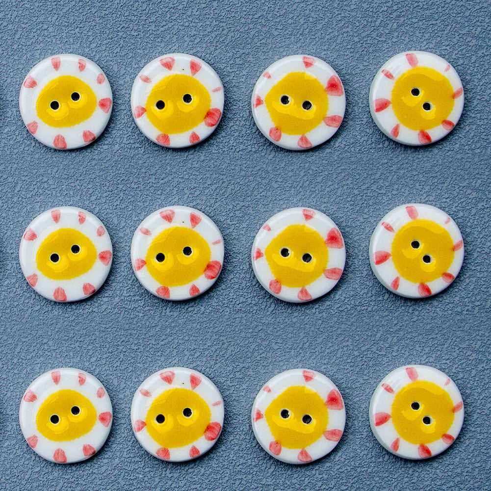 Round ceramic buttons with two-hole design, yellow sun faces on white (6-pack)