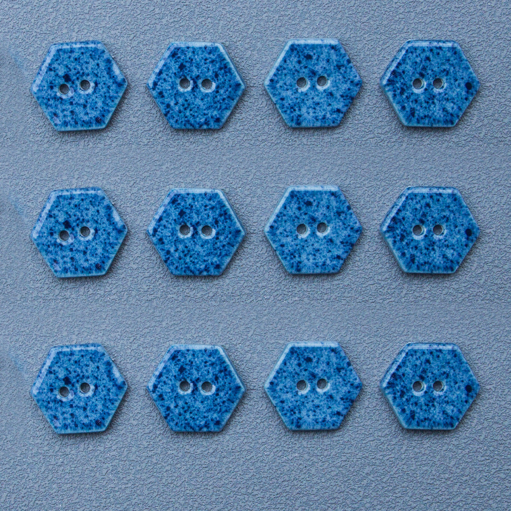 Navy blue hexagonal ceramic buttons with two holes each, speckled finish