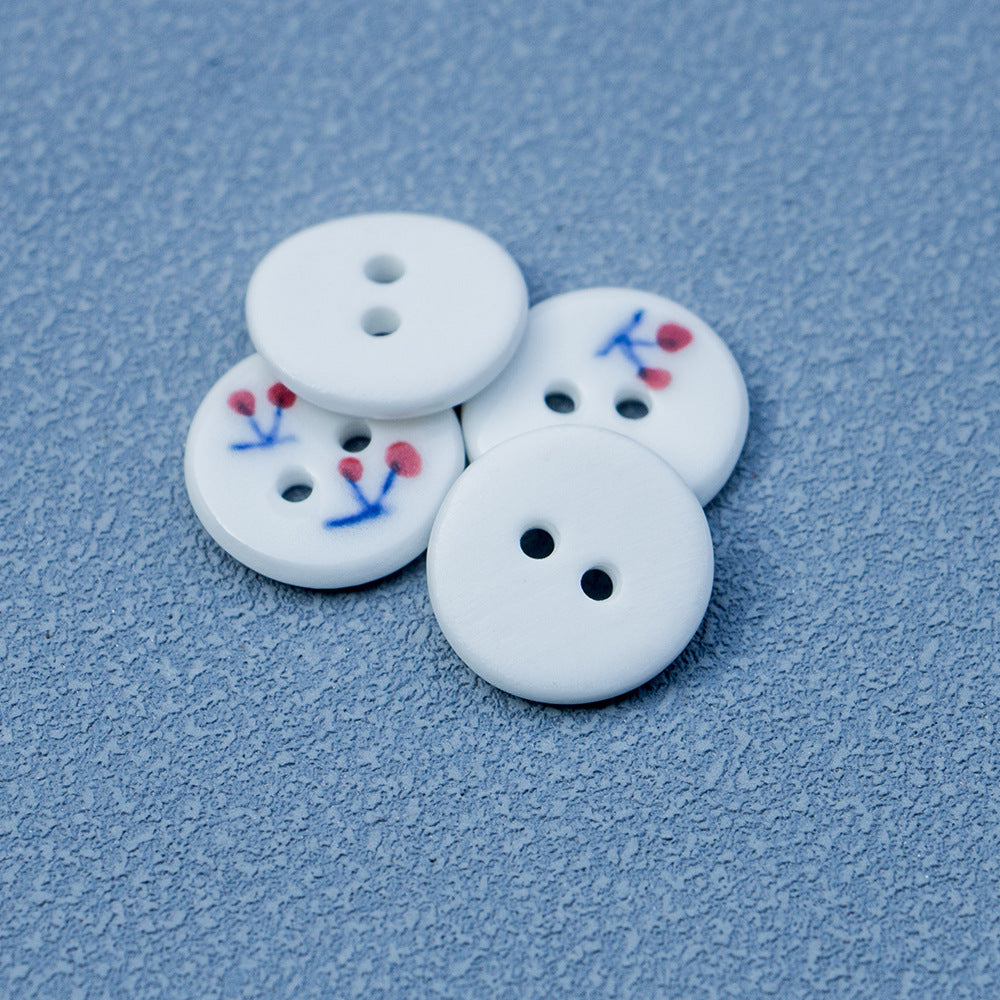 Round ceramic buttons, 2-hole, white with red cherries and blue floral sprigs