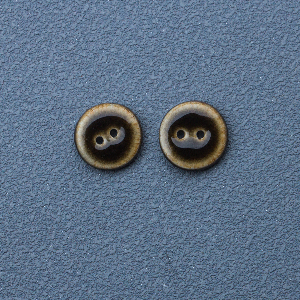 Dark brown glazed ceramic button, round, two-hole front view