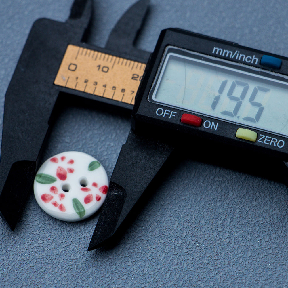 Round ceramic button, white with red flowers and green leaves, 2-hole, ~19.5mm
