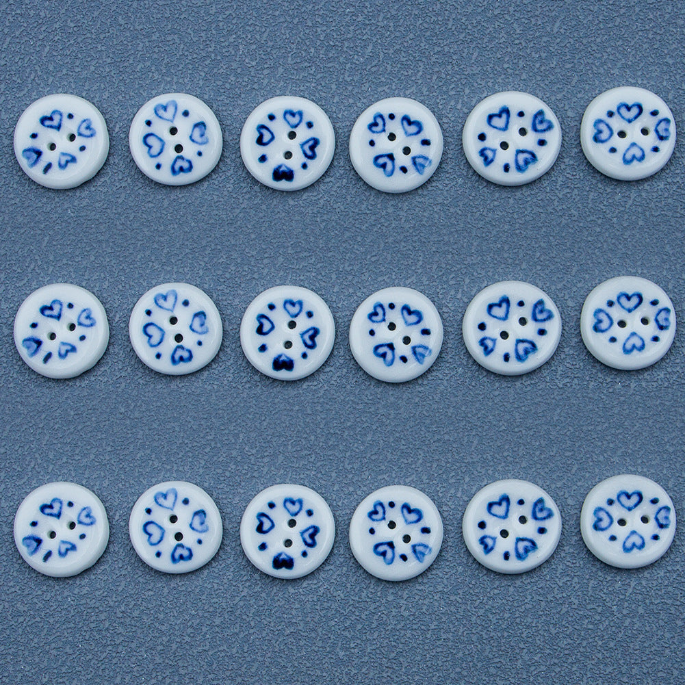 Row of blue-and-white porcelain heart ceramic buttons, multiple round faces with shank holes