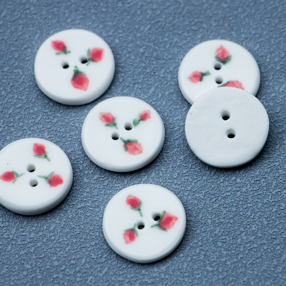 Round ceramic buttons with strawberry motifs; two-hole button faces.