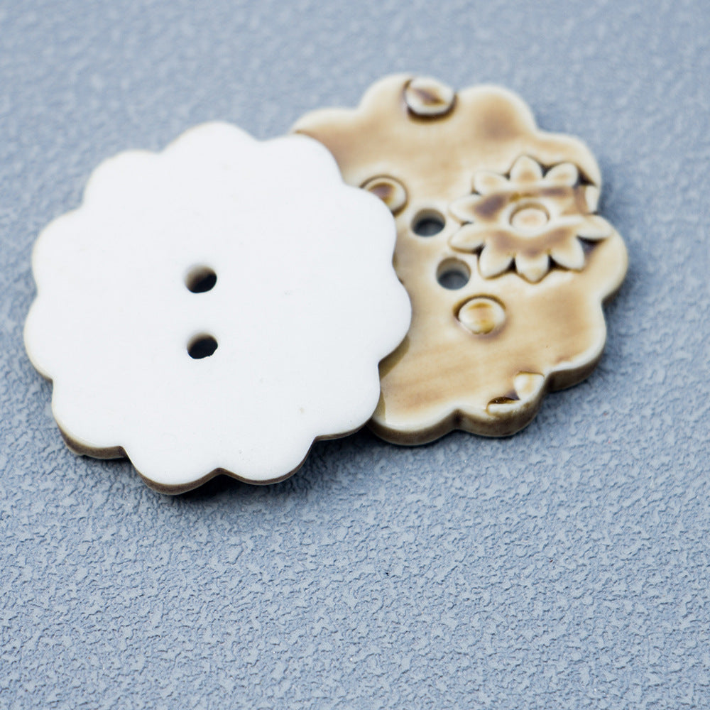Tawny ceramic button front with floral relief; white back shows two holes