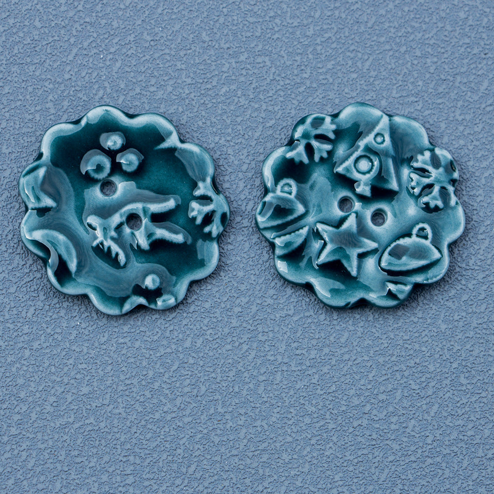 Round ceramic 2-hole buttons with snowflake elk motif in cyan/teal (2 pcs)