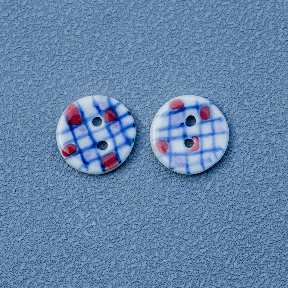 Ceramic 2-hole buttons, blue plaid with red accents, round painted design (2 shown)