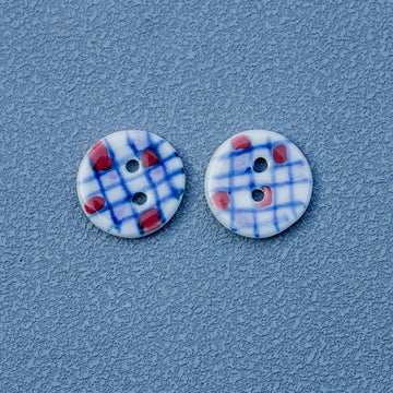 Ceramic 2-hole buttons, blue plaid with red accents, round painted design (2 shown)