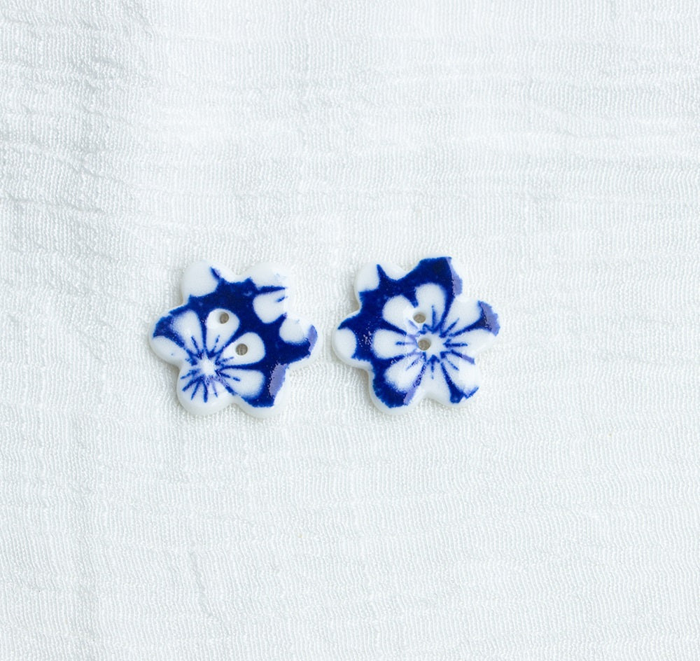 Blue ceramic flower buttons with two holes, pair view