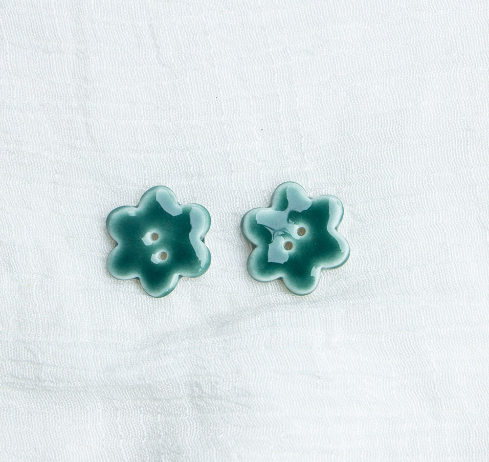 Green ceramic flower buttons with two holes, pair view