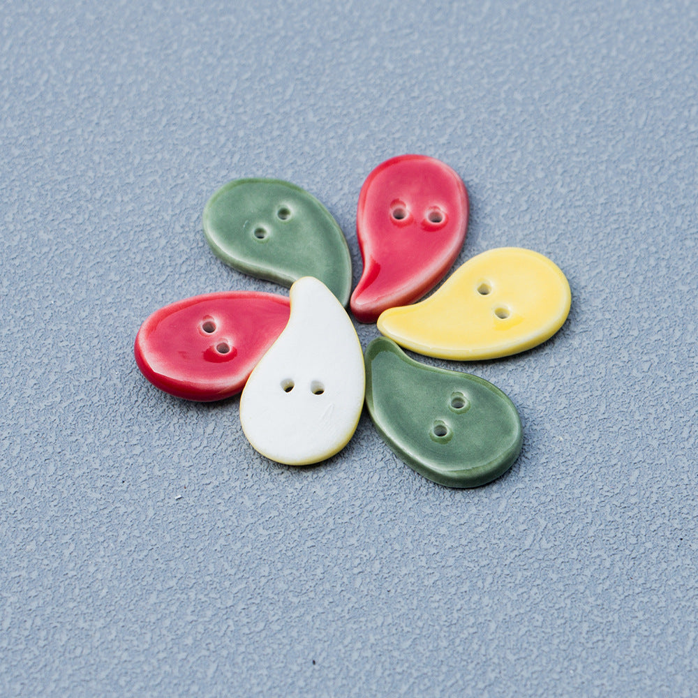 Handmade ceramic quote-shaped buttons in red, green, yellow and white, 2 holes