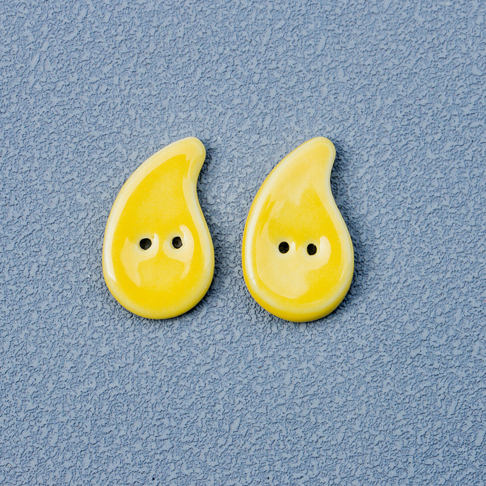 Yellow quote-shaped handmade ceramic buttons, 2 holes