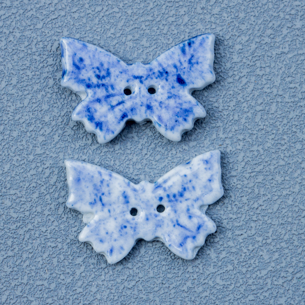 Close-up blue-and-white speckled 2-hole ceramic butterfly button, 26mm