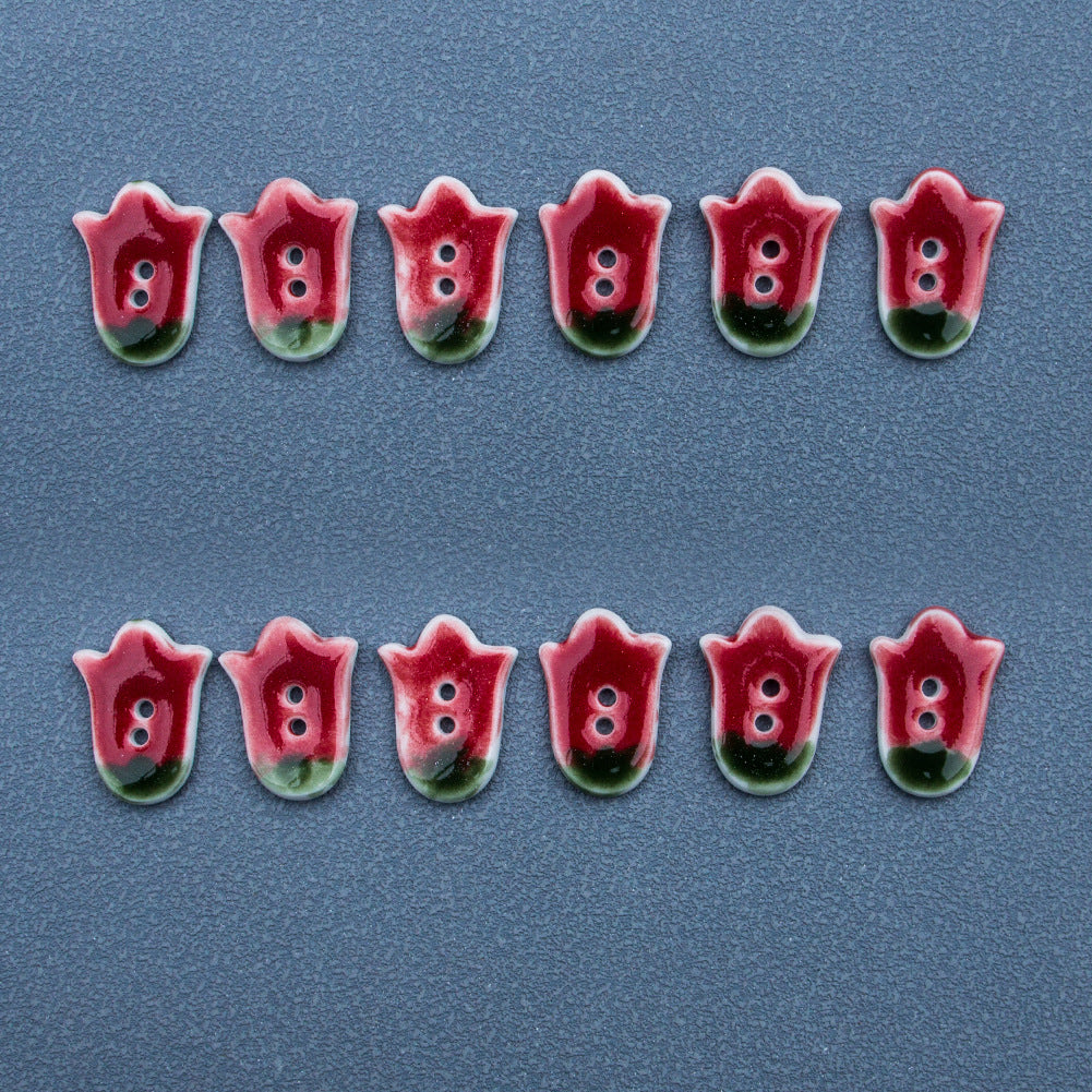 Multiple red tulip ceramic buttons with two holes each, arranged in two rows