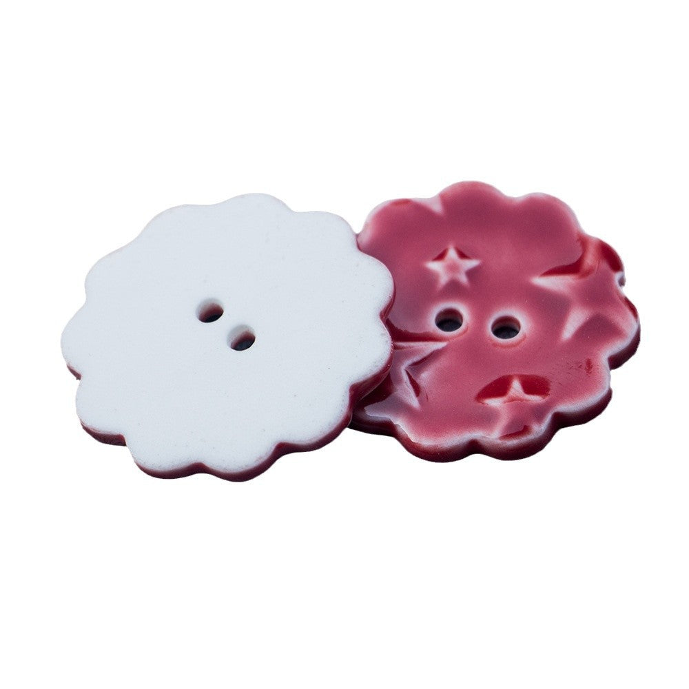 Red and white round ceramic buttons with star pattern, two-hole design