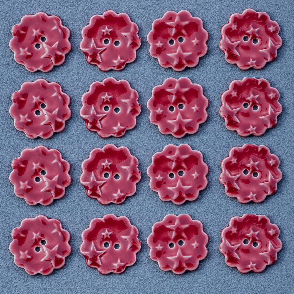 Many red round ceramic buttons with star pattern and two-hole center