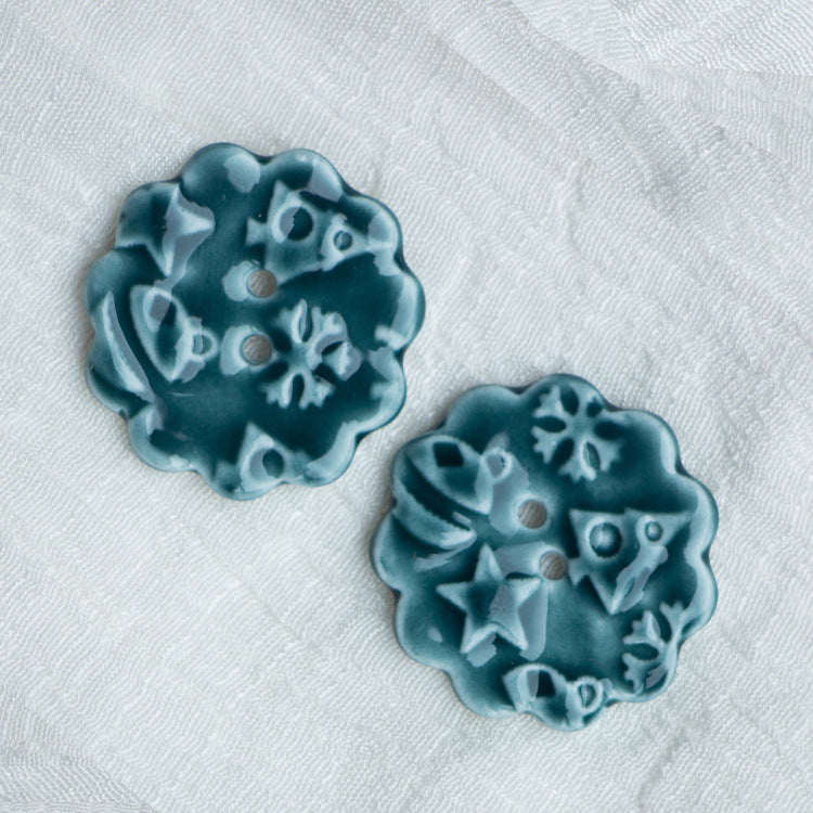 30mm ceramic two-hole flower buttons in teal-blue with sculpted floral pattern (2 pcs)