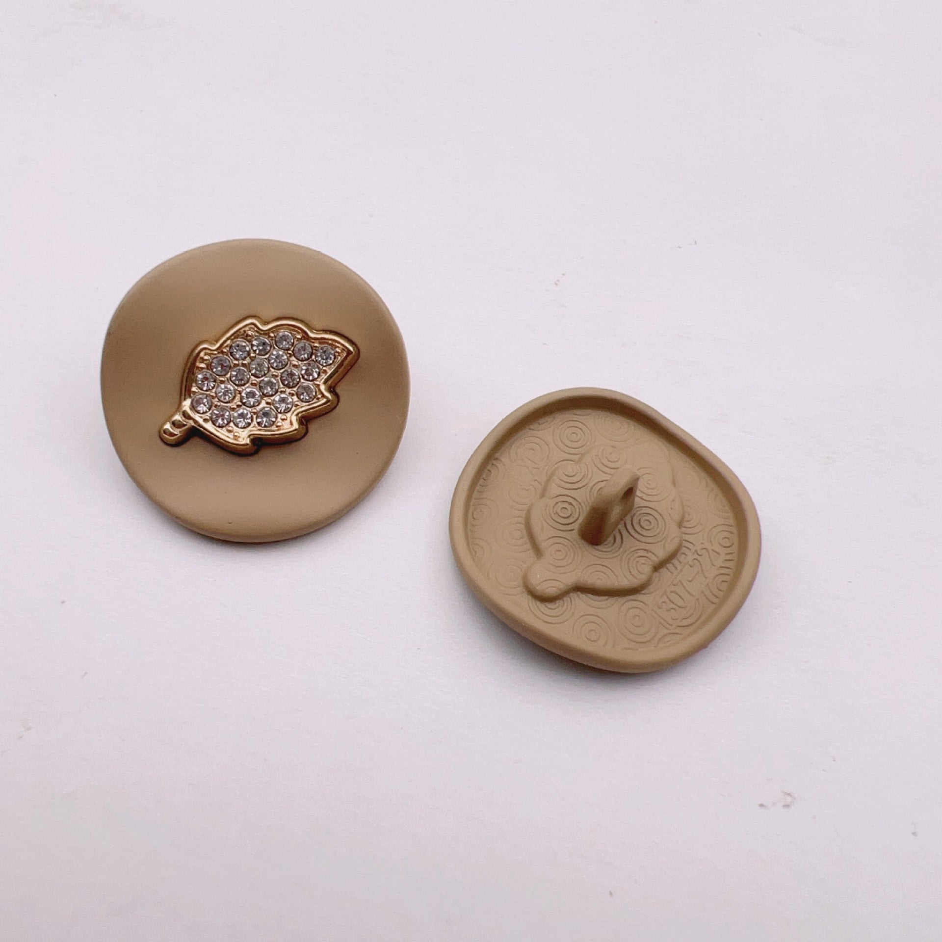 Khaki arched jeweled button with gold leaf trim and rhinestone leaf design