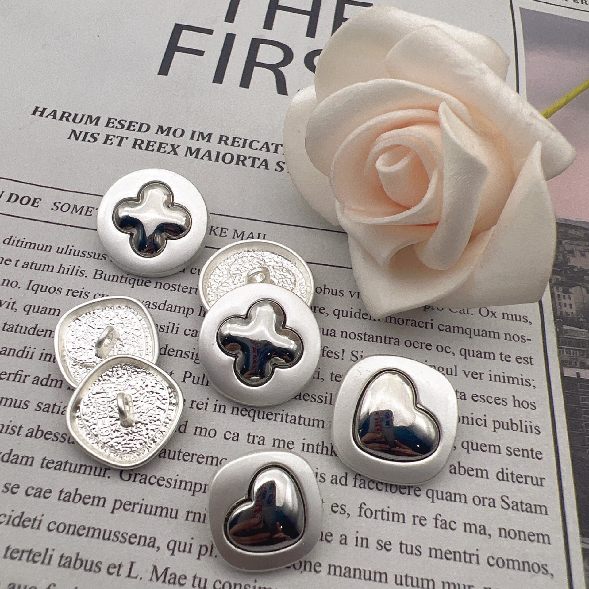 25mm pearlized silver heart cross metal shank buttons, dark heart inlay, close-up fronts
