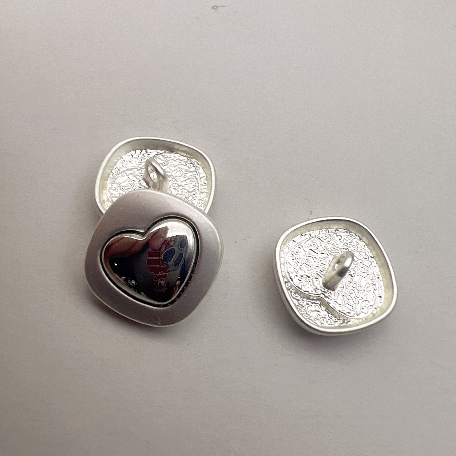 Pearlized silver heart cross metal shank buttons with dark heart inlay and textured back