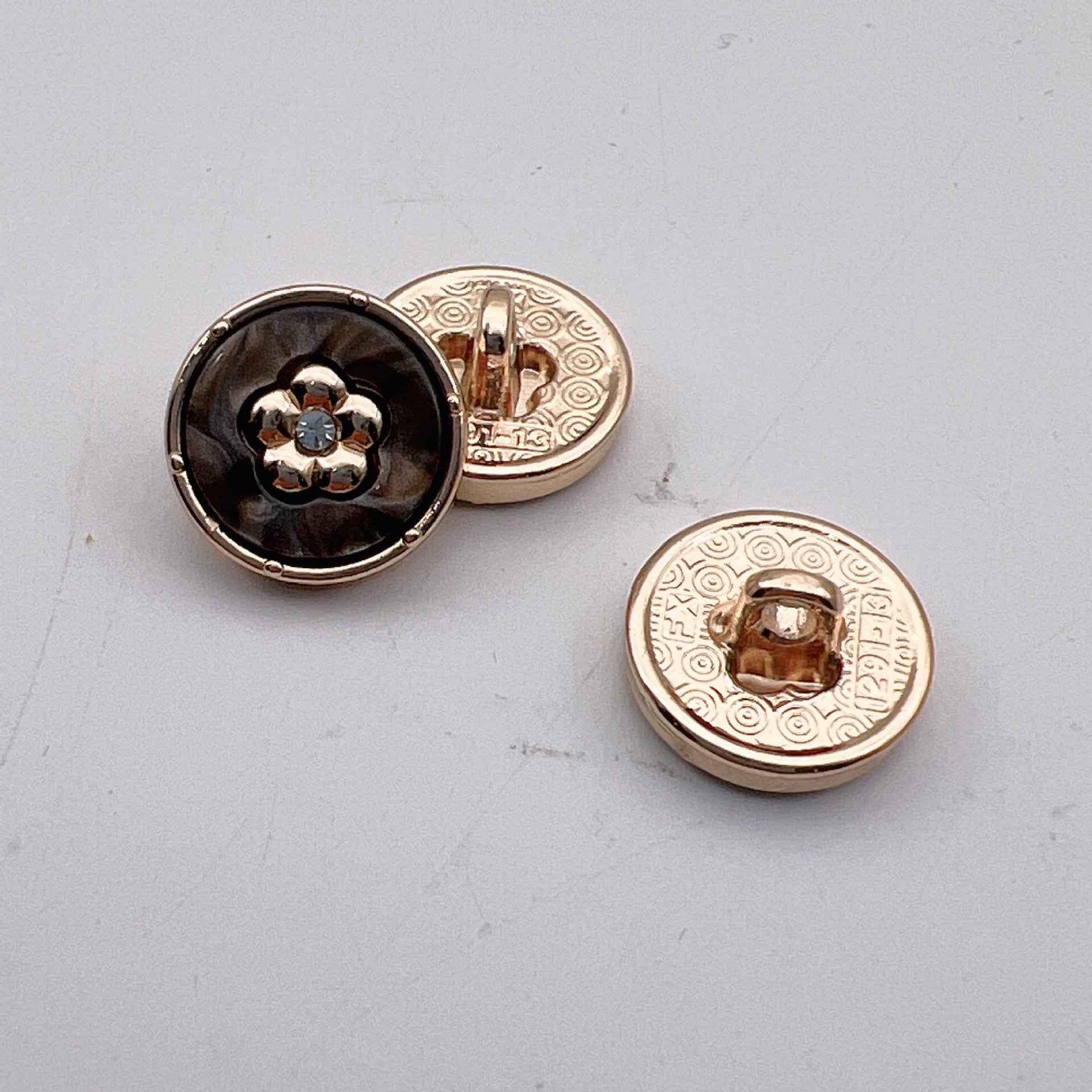 12.5mm round diamond-look metal button, Black, back view with engraved border