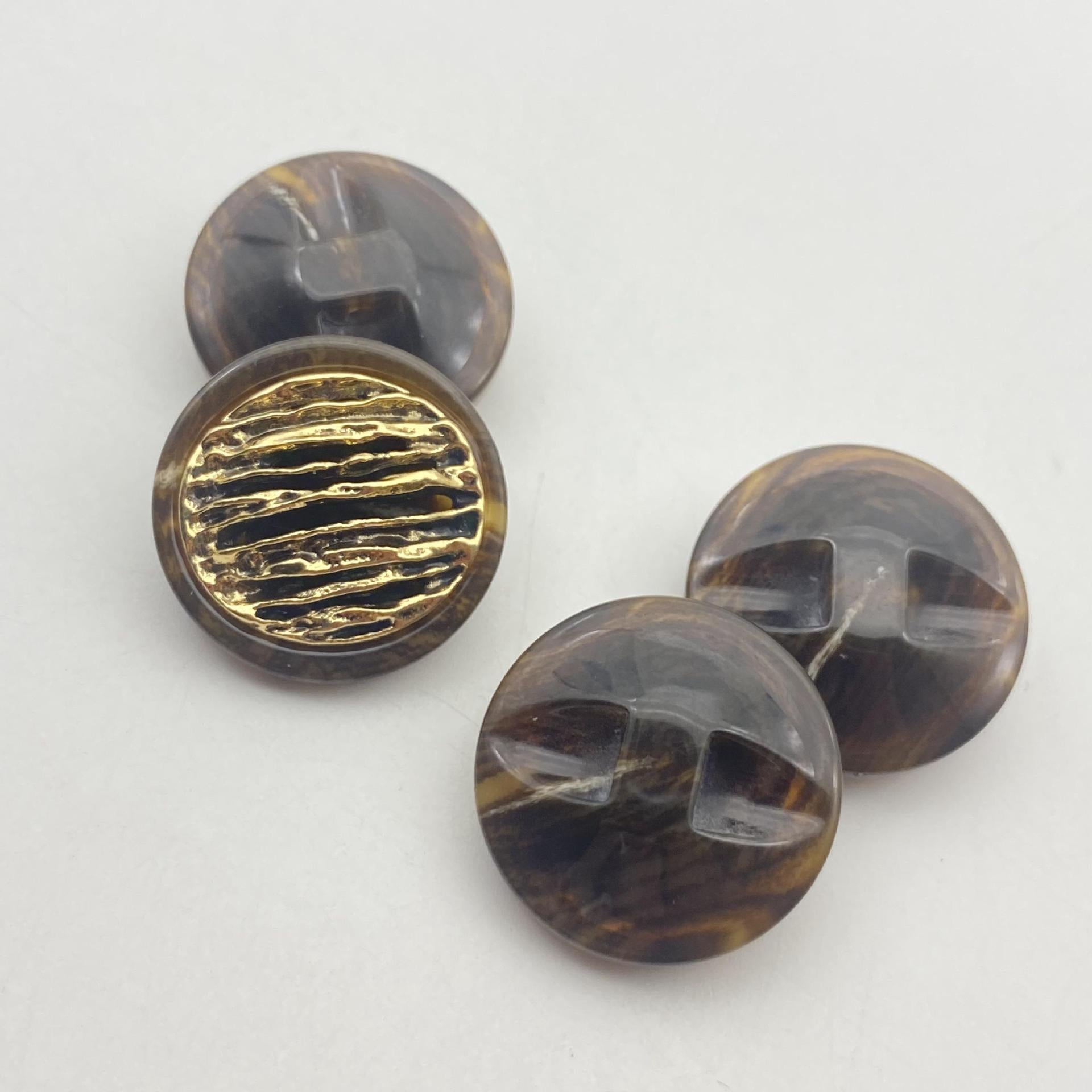 Dark smoky resin button (brown/gray), gold ridged face with gold-tone chain rim