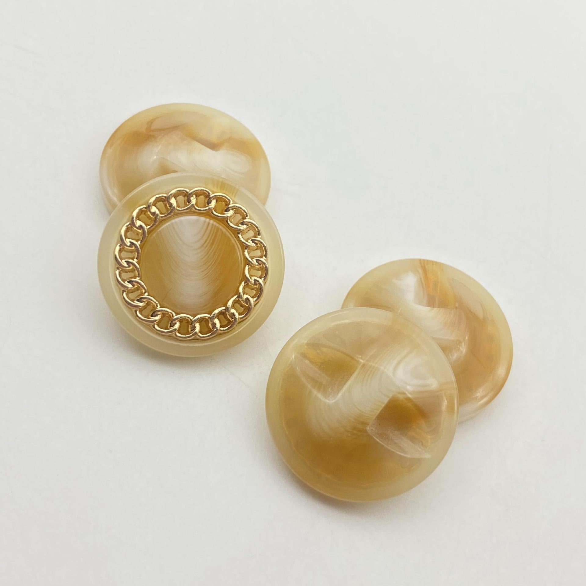 Translucent amber 25mm resin button with gold-tone chain mesh rim, round face