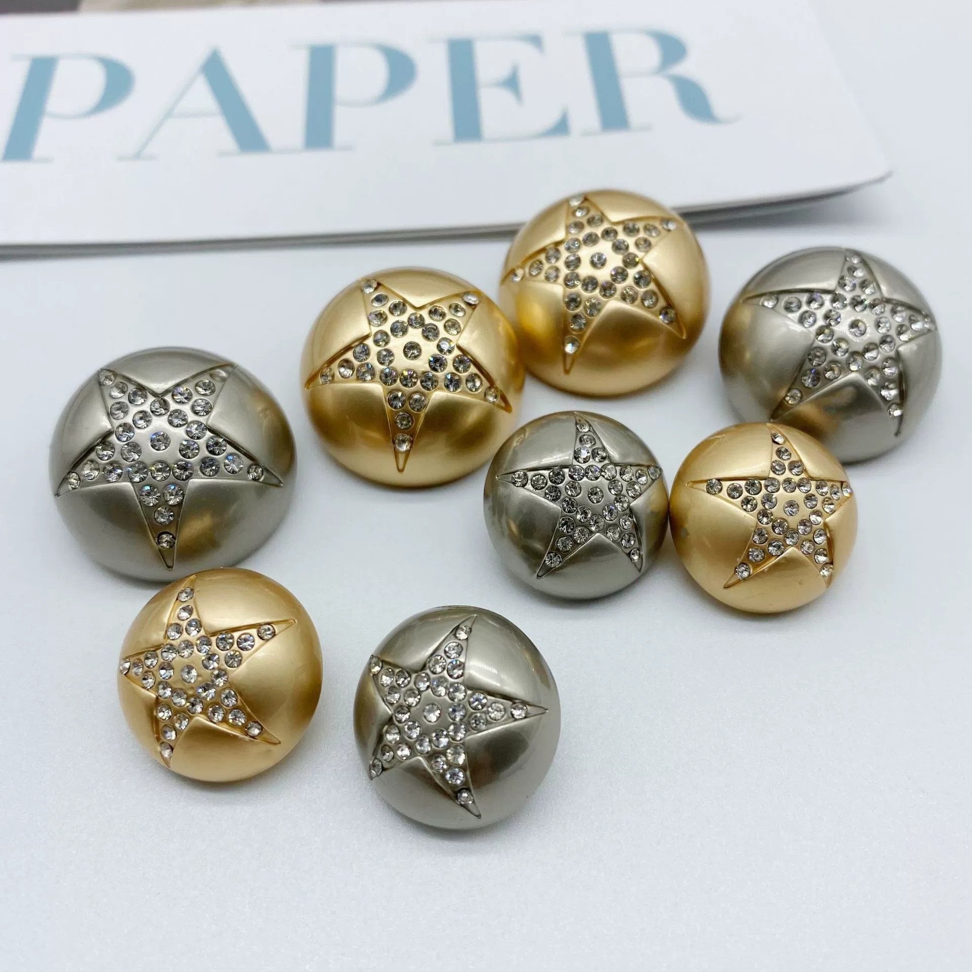 Gold and silver star rhinestone sew-through metal buttons, mushroom shape, front view