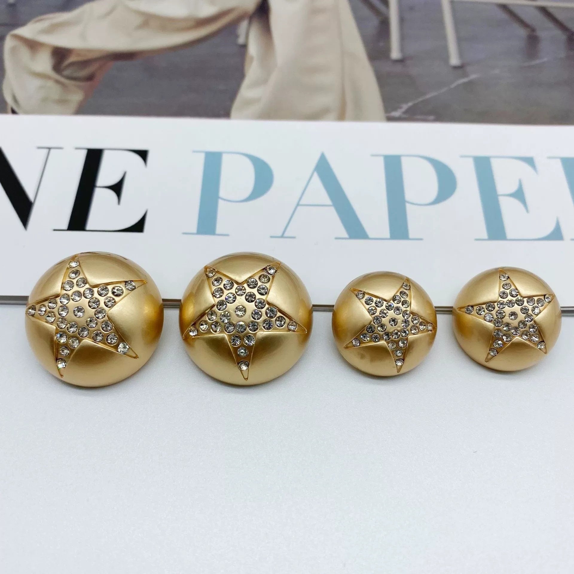 Gold star rhinestone mushroom sew-through buttons, four front views with sparkle star