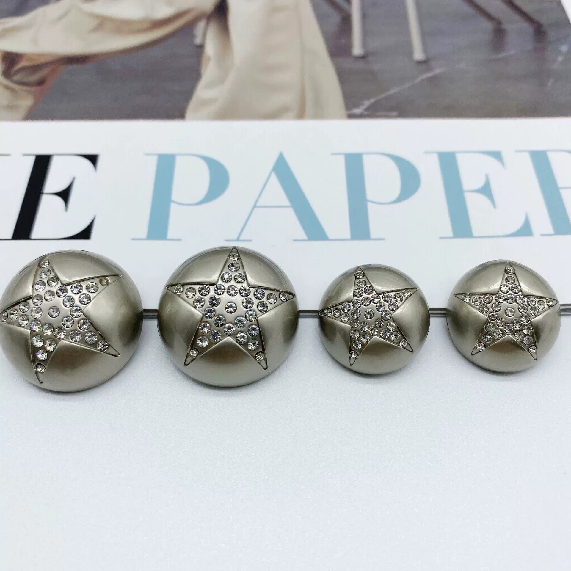 Silver star rhinestone mushroom sew-through buttons, four front views with rhinestone star