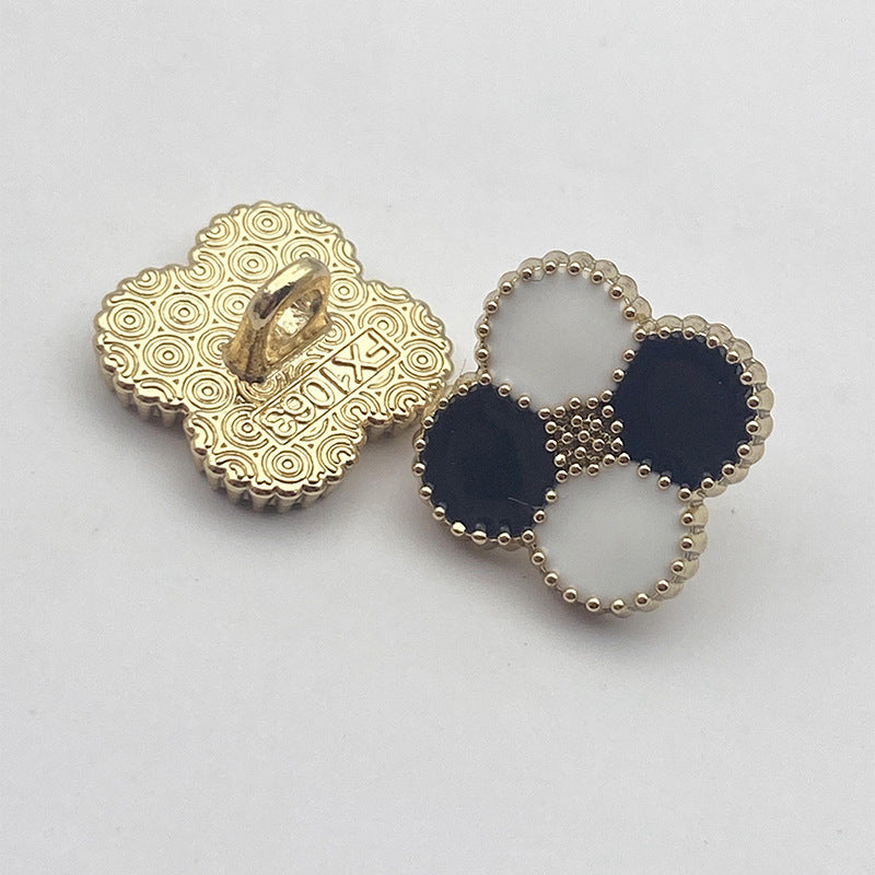 Four-leaf clover shank button pair: gold patterned back, navy and white bead trim