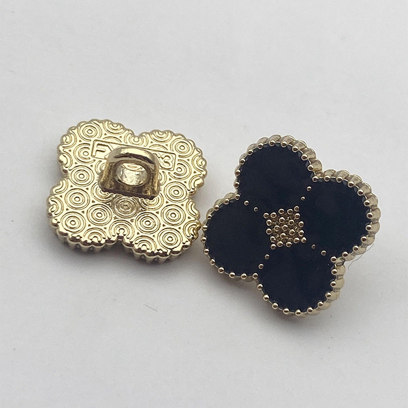 Four-leaf clover shank buttons: gold patterned back with dark navy bead trim and white dots