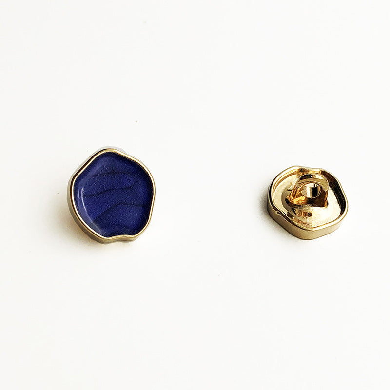Irregular high-gloss metal shank button with blue face, gold rim, and shank back