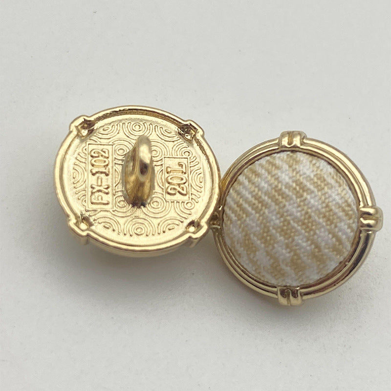 Houndstooth metal shank button pair, gold-tone frame, light blue and cream plaid fabric
