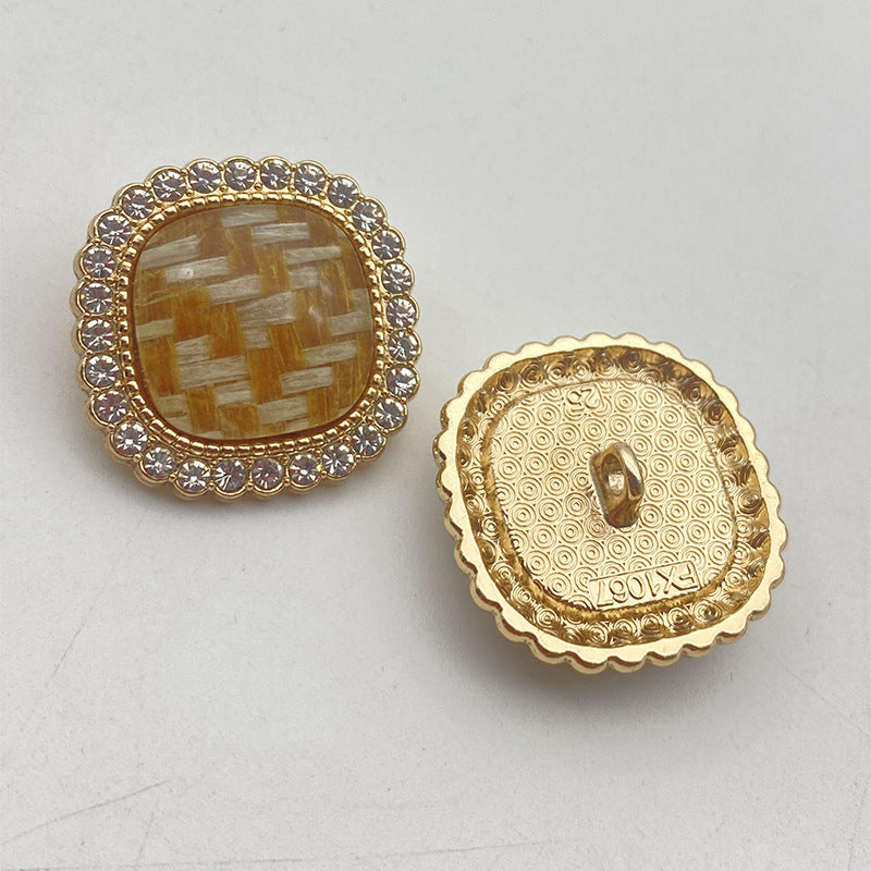 Gold-tone rhinestone-edged resin button, amber mosaic front and embossed back