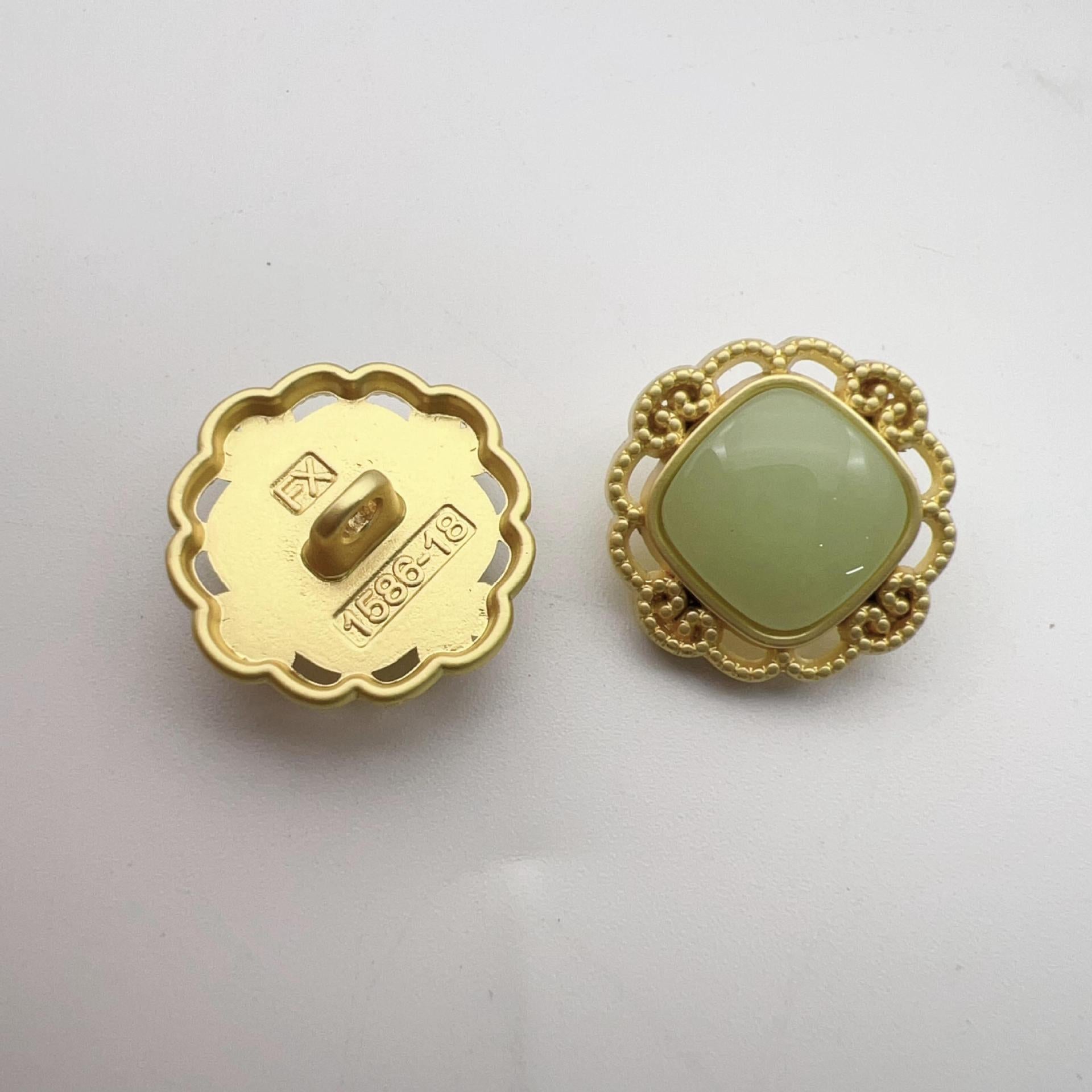Hollow pearl shank buttons: gold back with markings, green faux pearl front