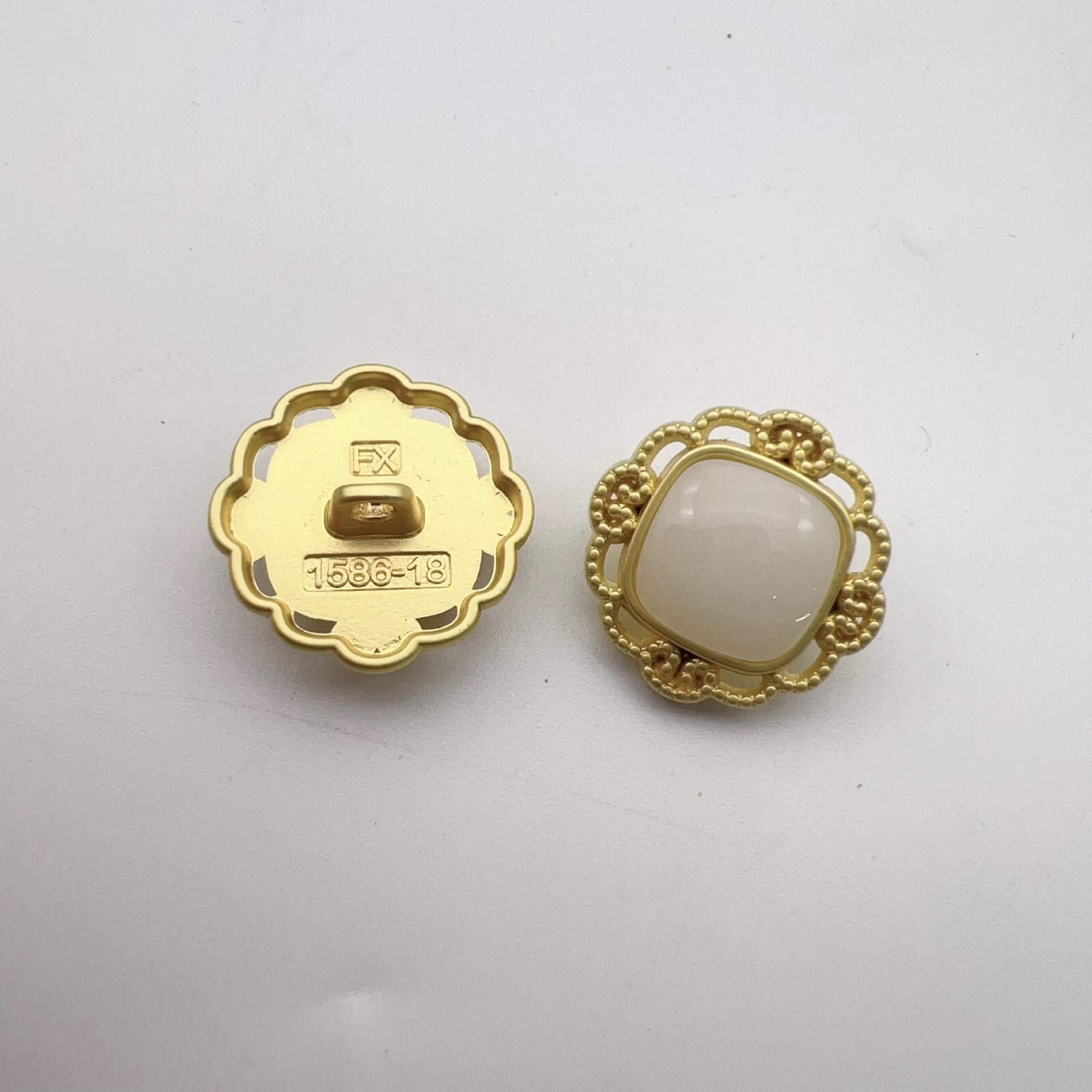 Hollow pearl shank buttons: gold back with markings, light faux pearl front in gold