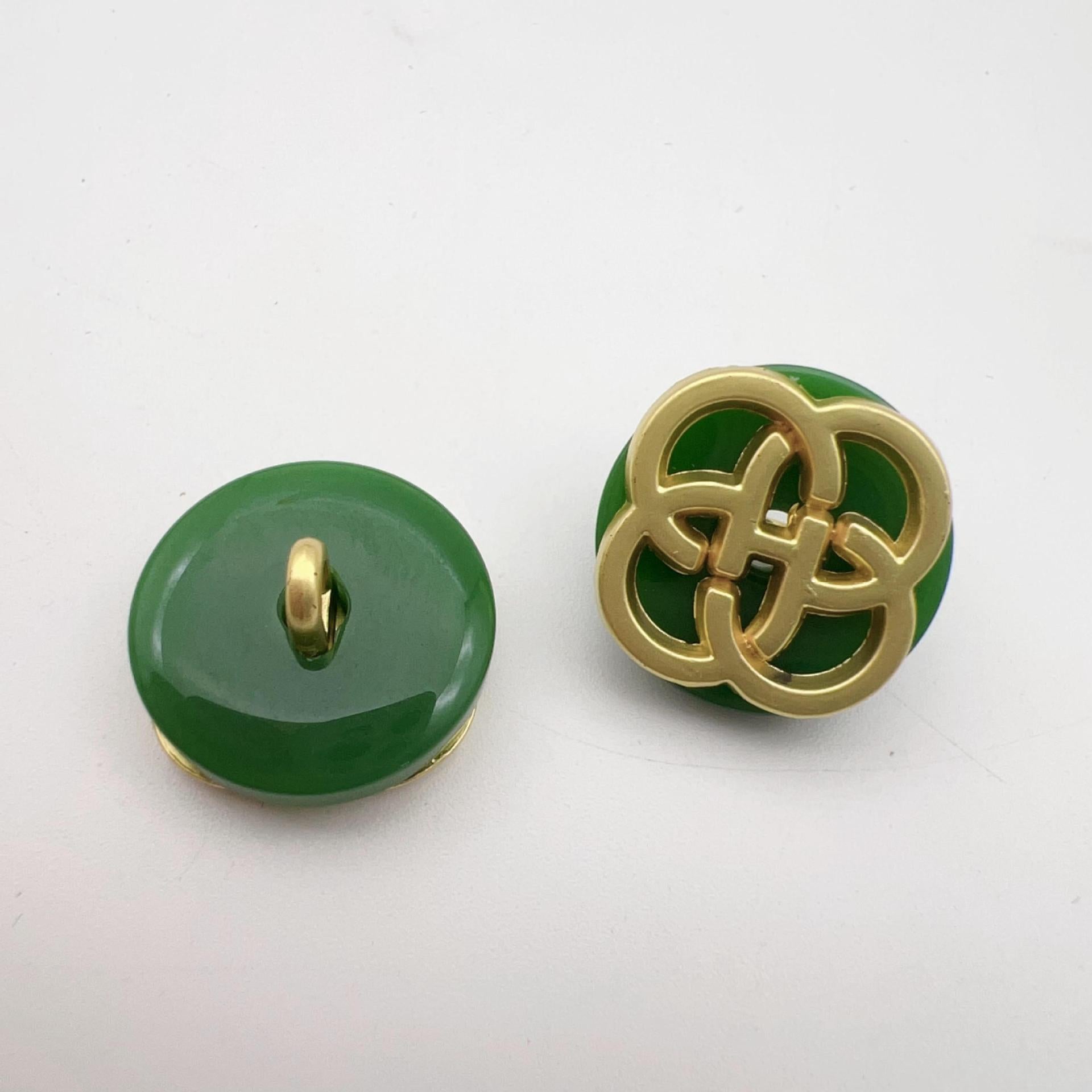 Green resin button with gold-tone four-leaf clover shank, smooth back