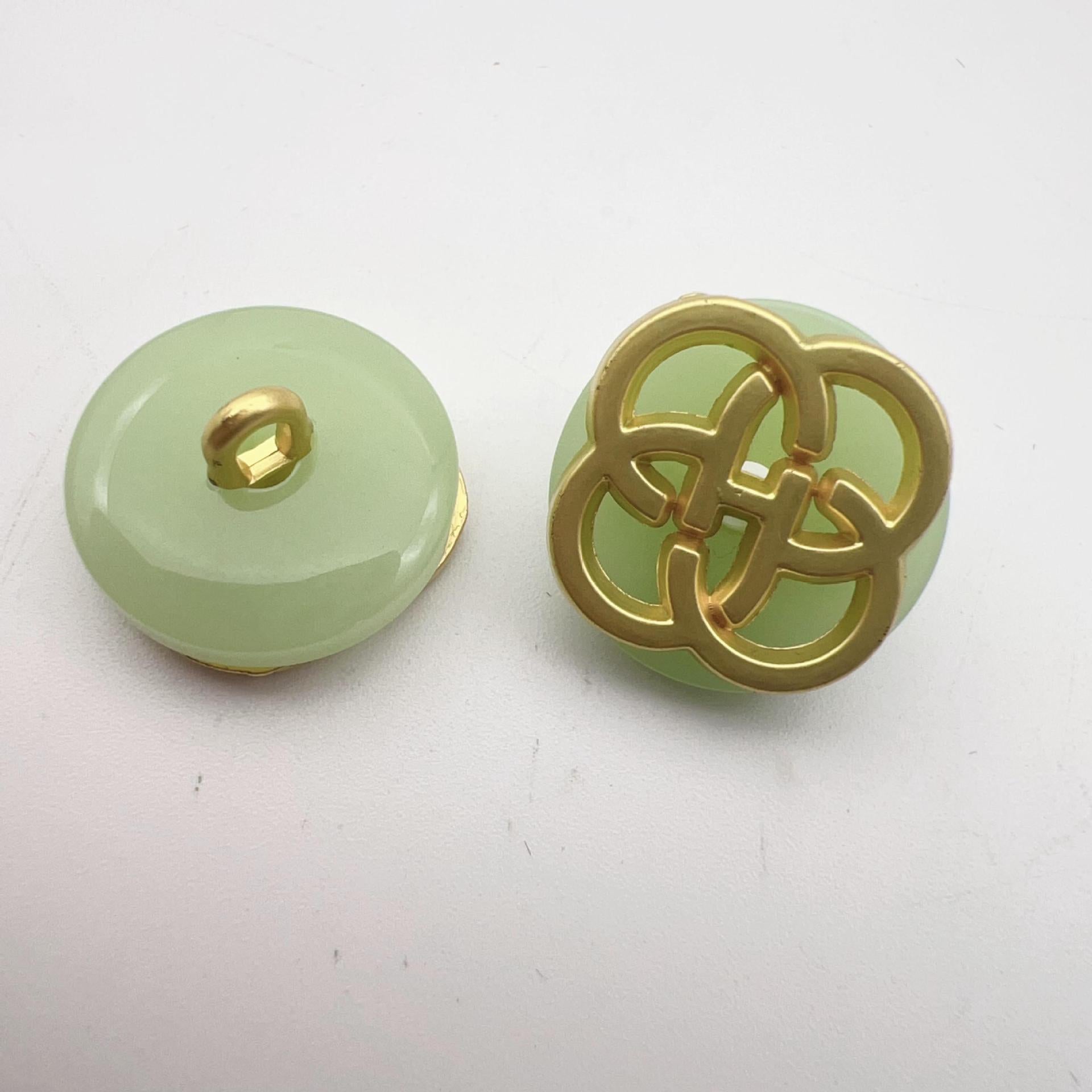 Light green resin button with gold-tone four-leaf clover shank