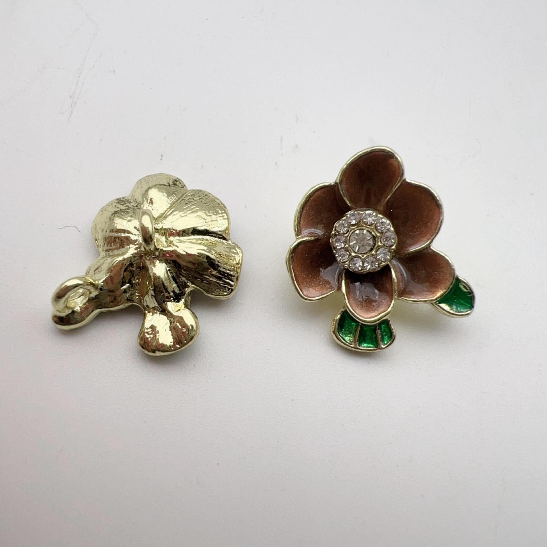Brown plum blossom alloy shank buttons with rhinestone center and green enamel leaves