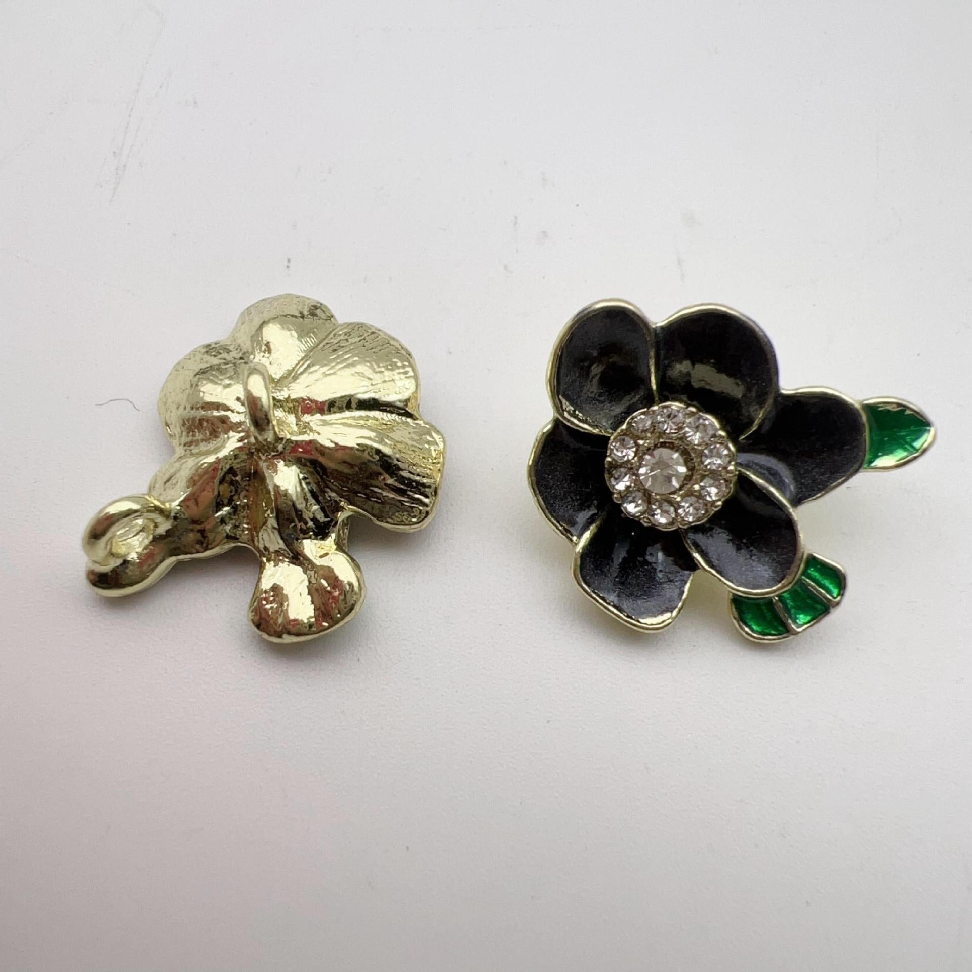 Dark plum blossom alloy shank buttons with rhinestone center and green enamel leaves